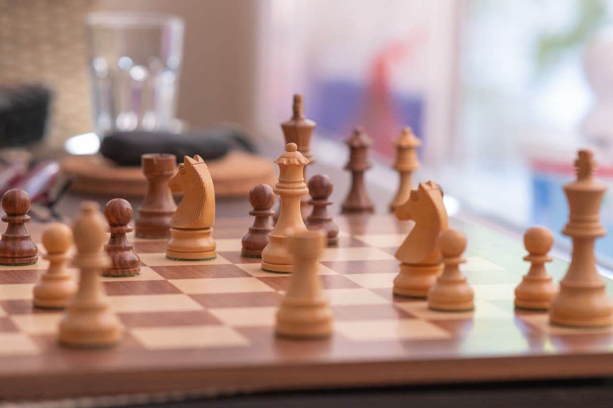 A chess board mid-game, pieces in play